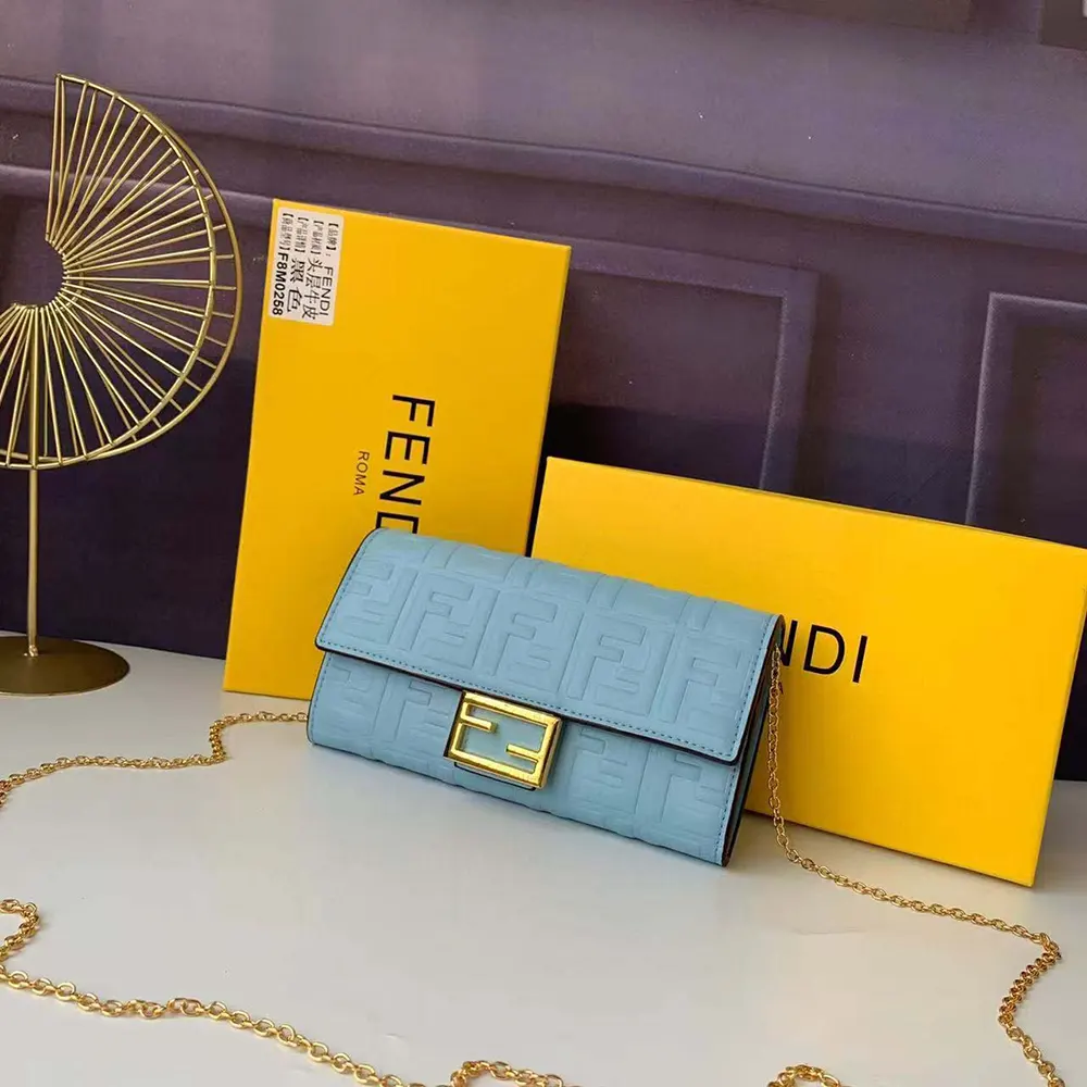 Close-up of gold hardware and chain detail on Fendi blue Nappa leather wallet