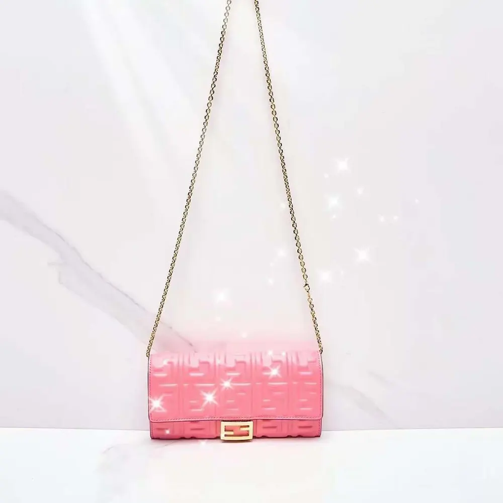 Side angle showing compact silhouette of Fendi Women Baguette Continental Wallet in pink