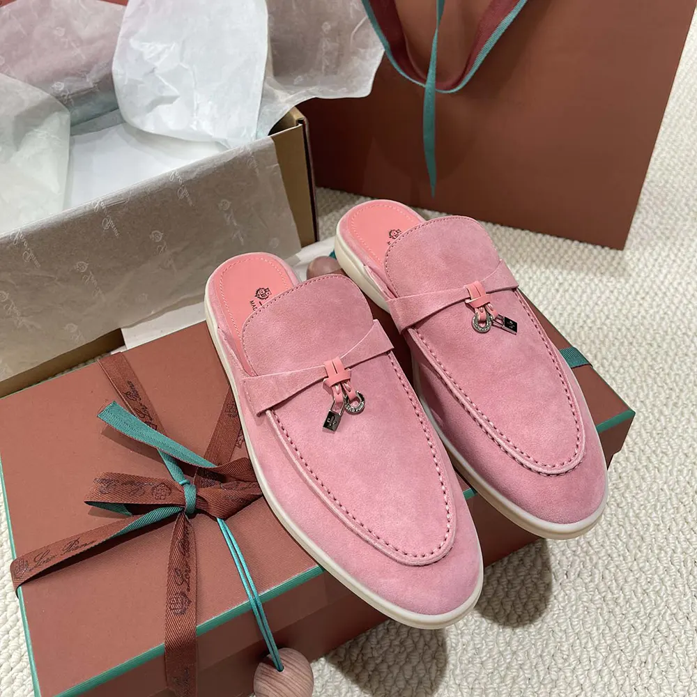 Close-up on pink suede and silver charm detail on loafer