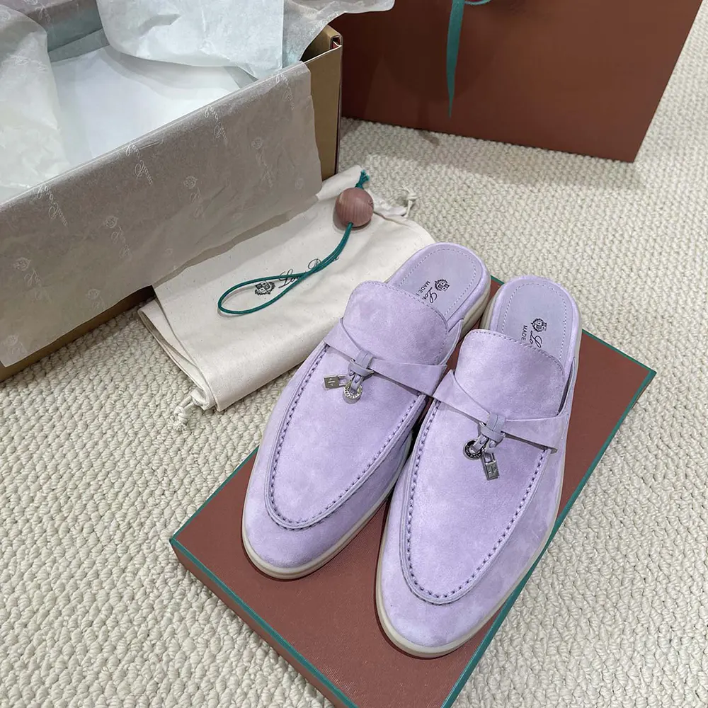 Close-up of purple suede and charm detail on Loro Piana loafers