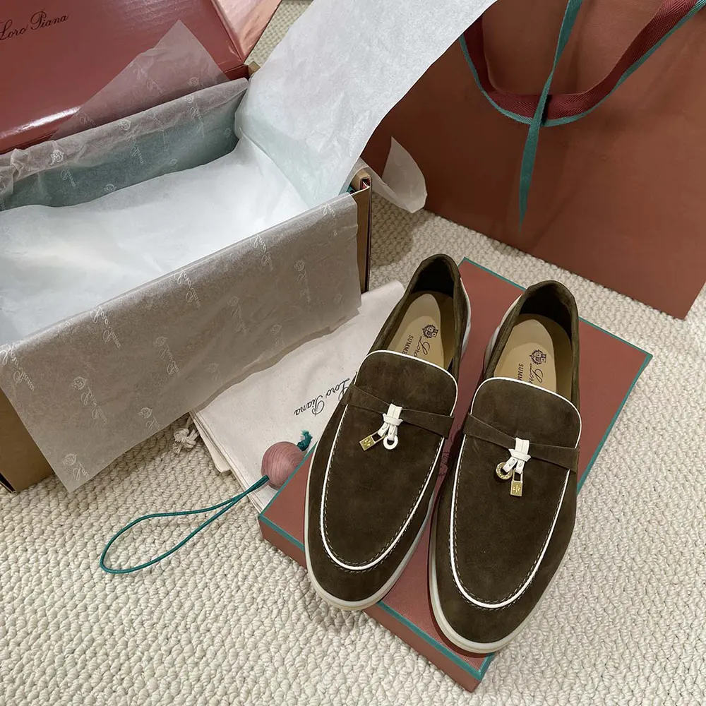 Close-up of dark green leather and charm detail on Loro Piana loafer