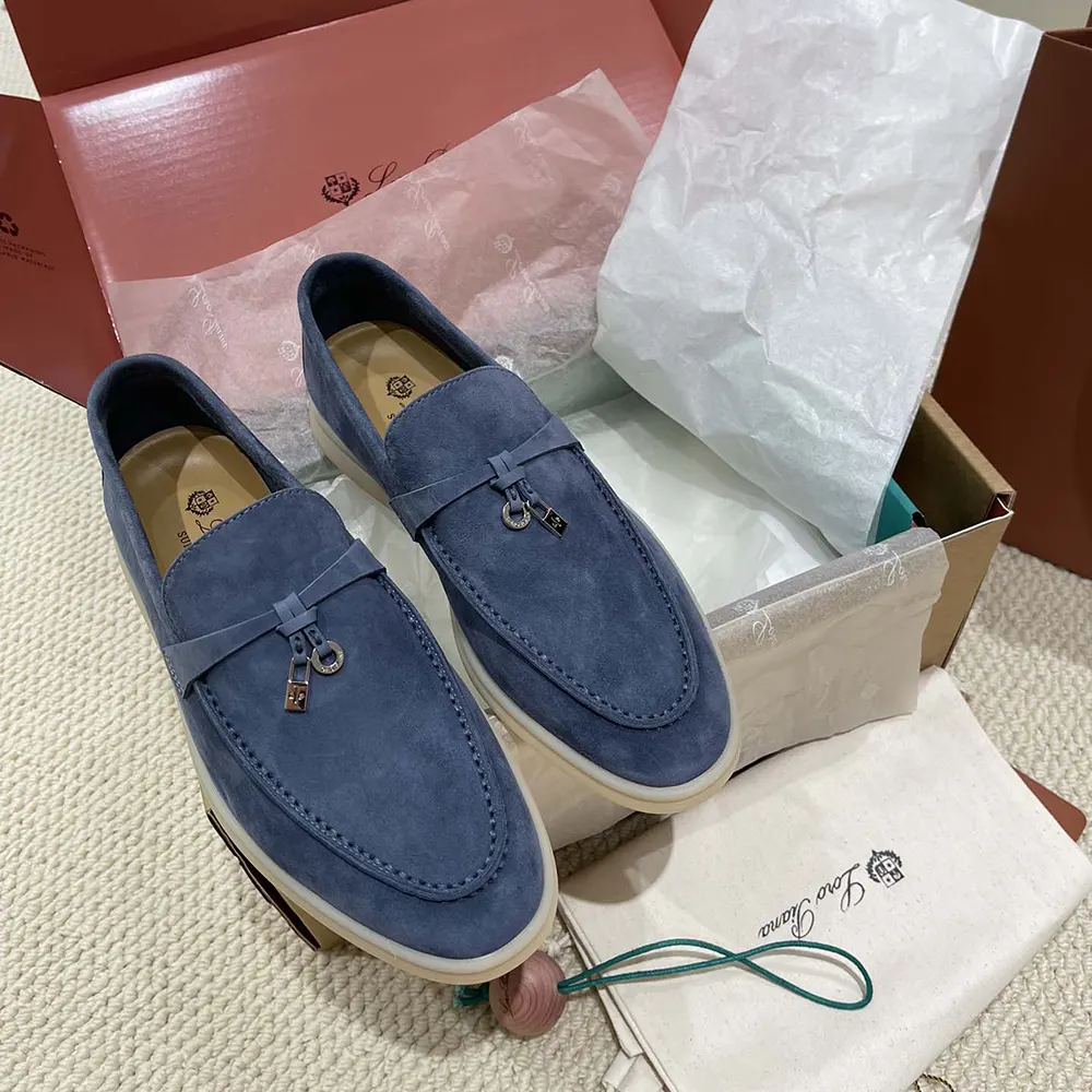 Close-up on silver-tone charm detail of Loro Piana Summer Charms loafers