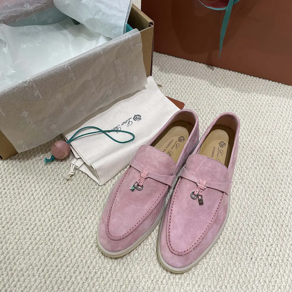 Top view close-up of pink suede and metal charm on Loro Piana loafers