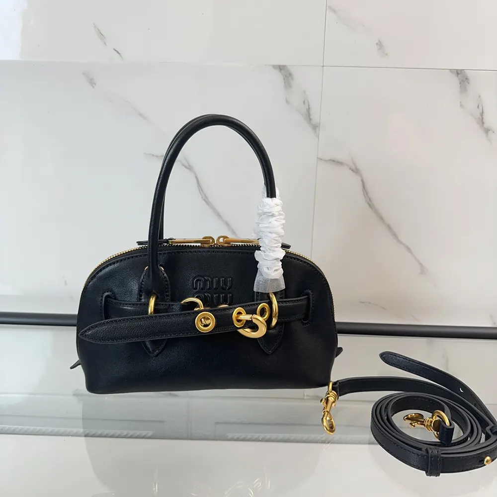Close-up of gold hardware on Miu Miu Women Aventure Nappa Leather Top-handle Bag-Black