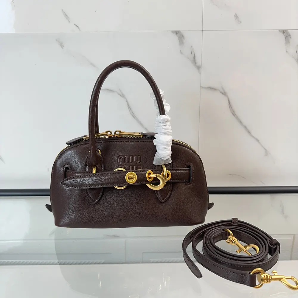 Close-up on silver-tone hardware of Miu Miu Women Aventure Bag Bordeaux