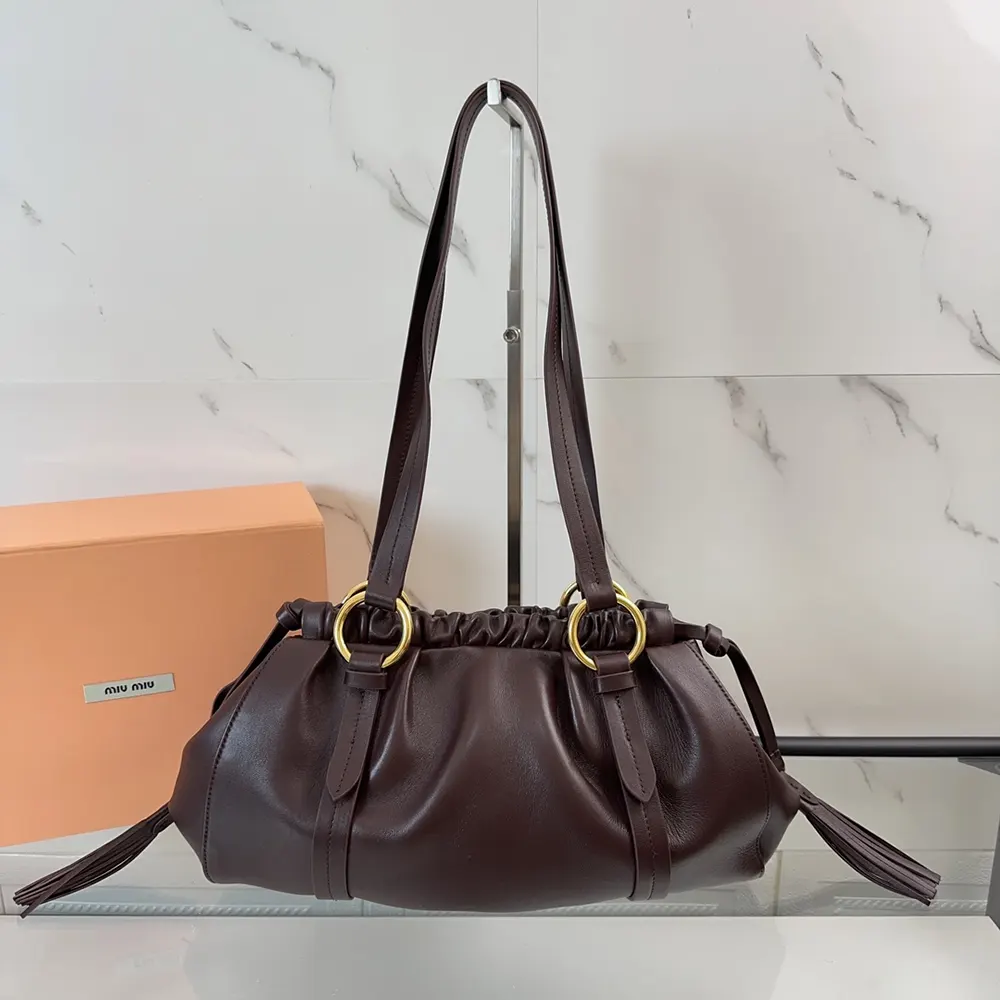 Close-up of gold hardware and nappa leather texture on Miu Miu Bordeaux bag