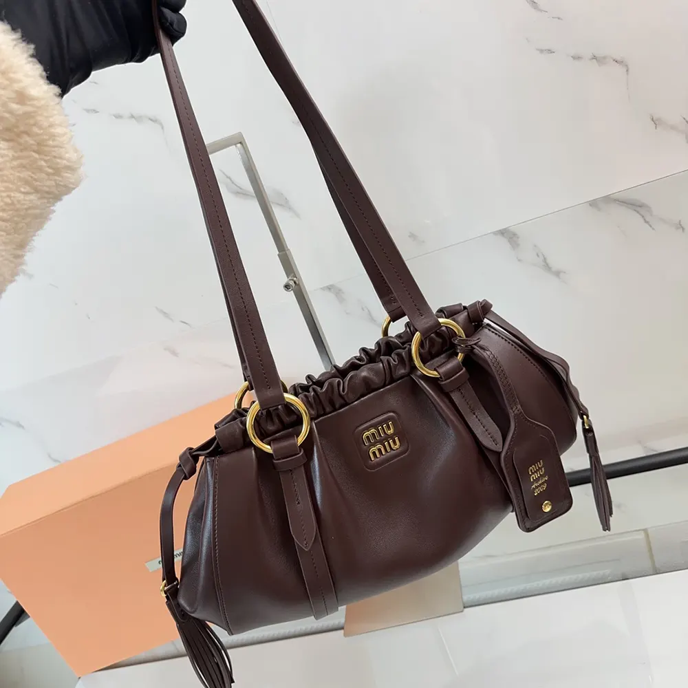 Side profile of Miu Miu Women Joie Nappa Leather Bag-Bordeaux with shoulder strap