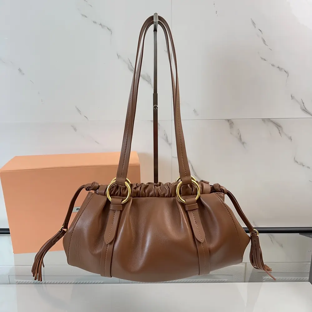 Close-up detail of gold-tone hardware on Miu Miu Women Joie Nappa Leather Bag-Brown