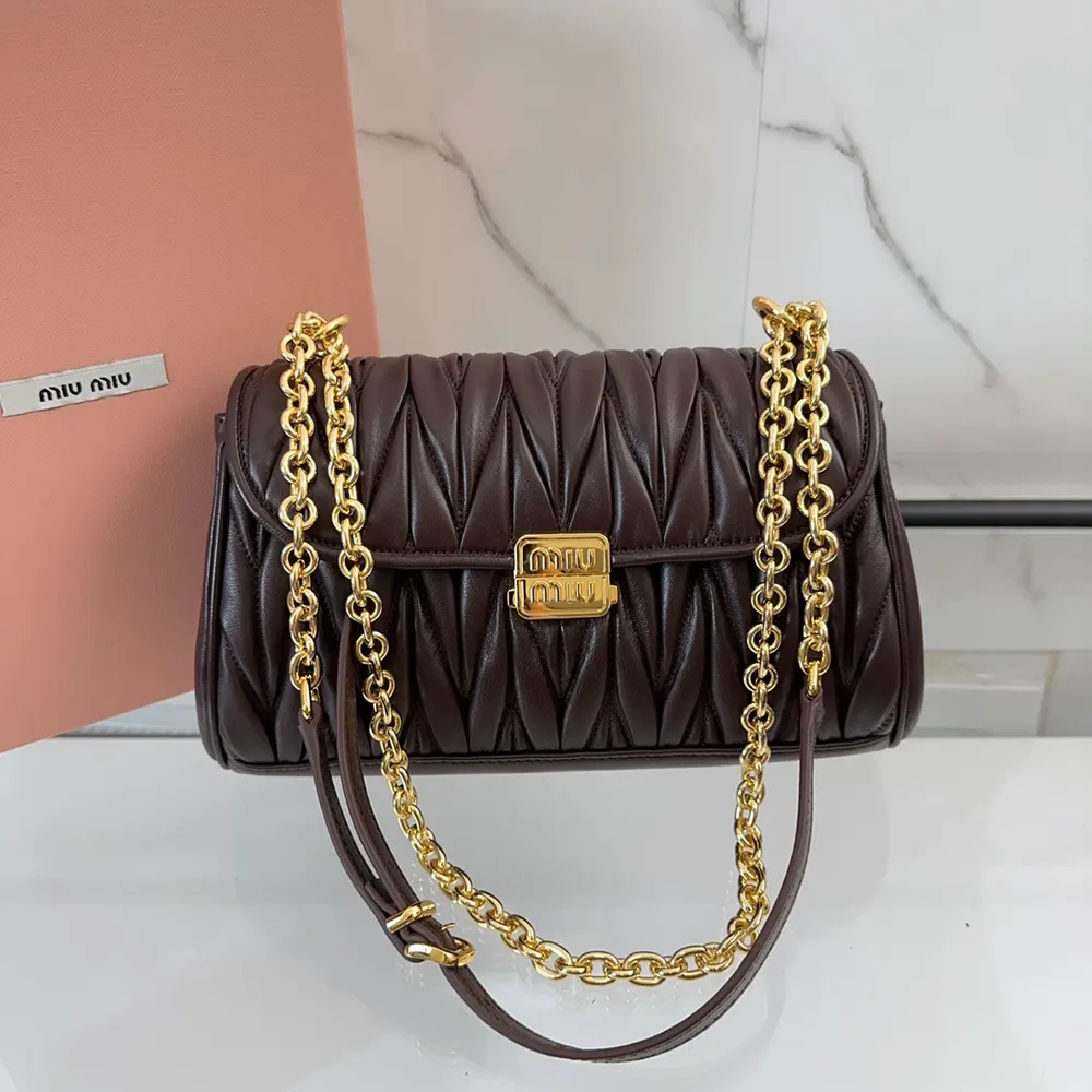 Close-up detail of matelassé quilting on Miu Miu Bordeaux shoulder bag
