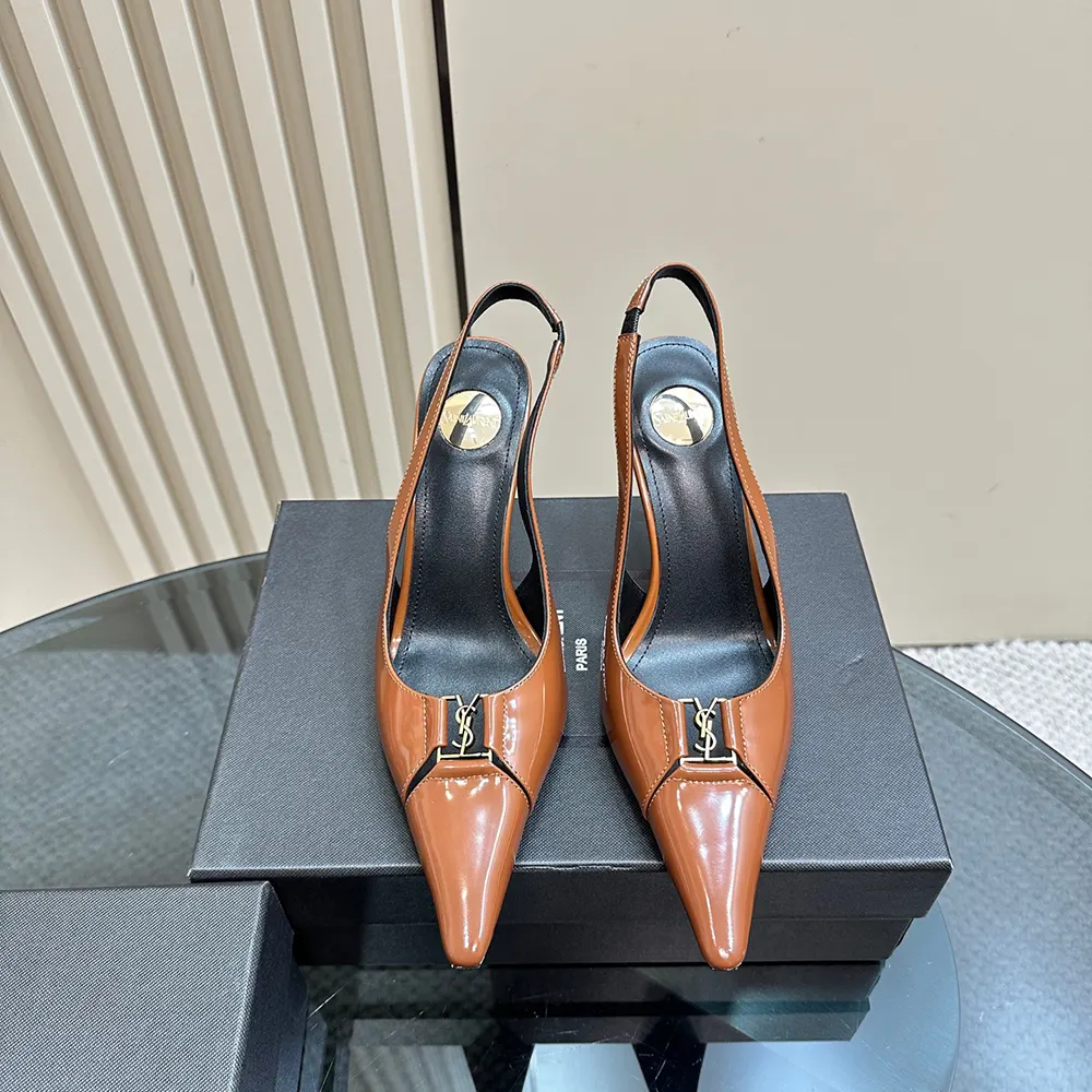 Close-up of gold-tone YSL logo on brown smooth leather slingback pumps