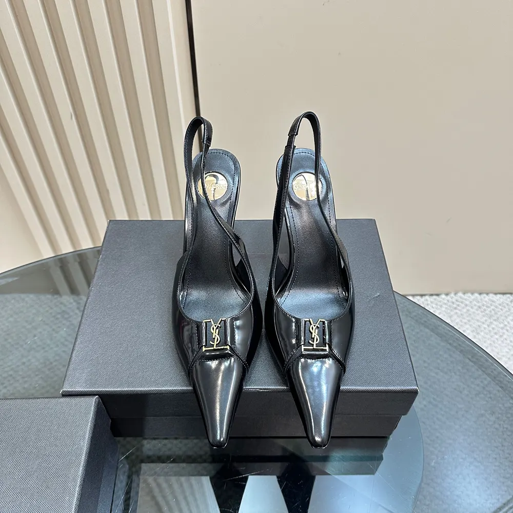 Close-up of gold YSL logo hardware on black Babylone Breteuil Slingback Pumps