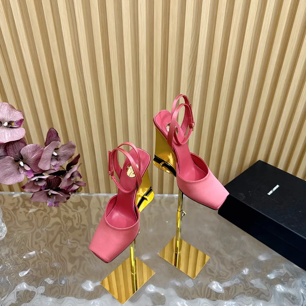 Close-up of gold-tone YSL buckle on La Scandale satin pink wedges