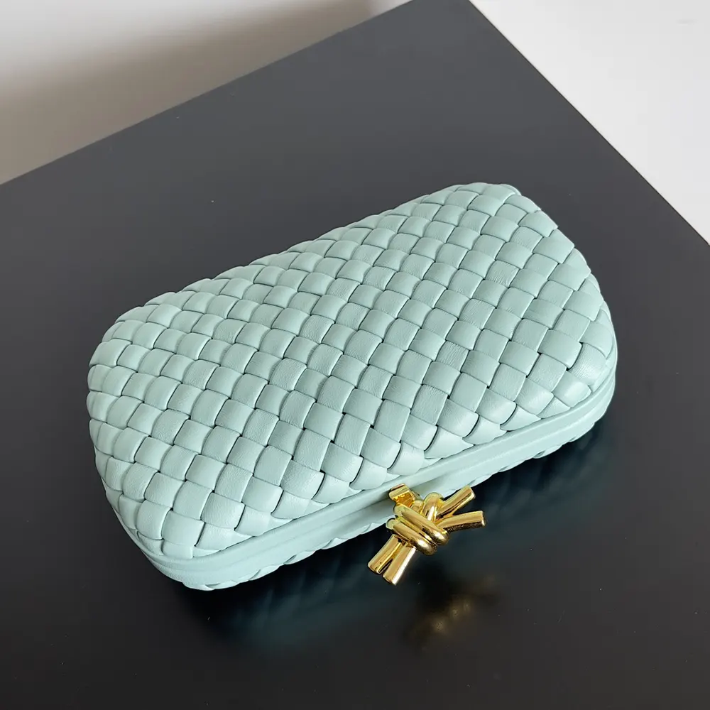 Side profile showcasing smooth calfskin of Bottega Veneta Women Knot Minaudière Clutch