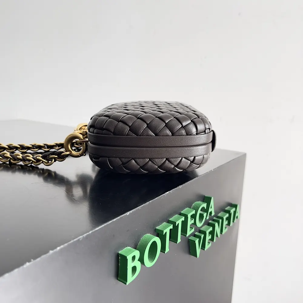Side angle showing structured silhouette of Bottega Veneta Women Knot Minaudière Clutch