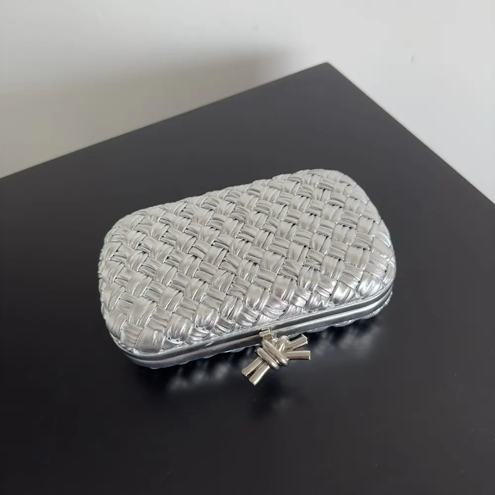 Side profile showing intrecciato leather texture on Bottega Veneta Women Knot Minaudiere