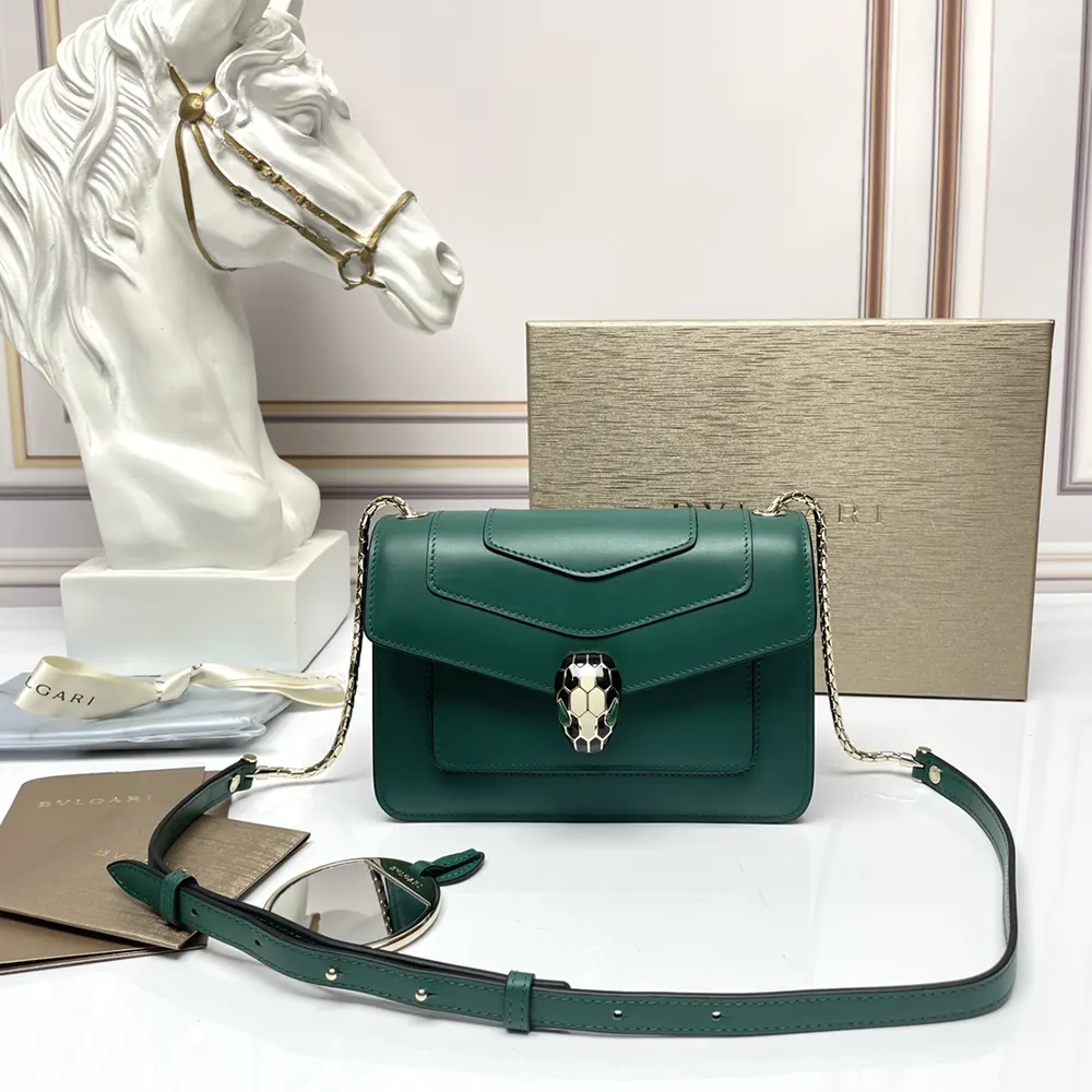 Close-up of Bvlgari snakehead clasp on the green mini shoulder bag