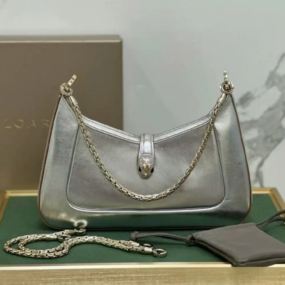 Close-up of silver snakehead twist-lock on Serpenti Baia shoulder bag