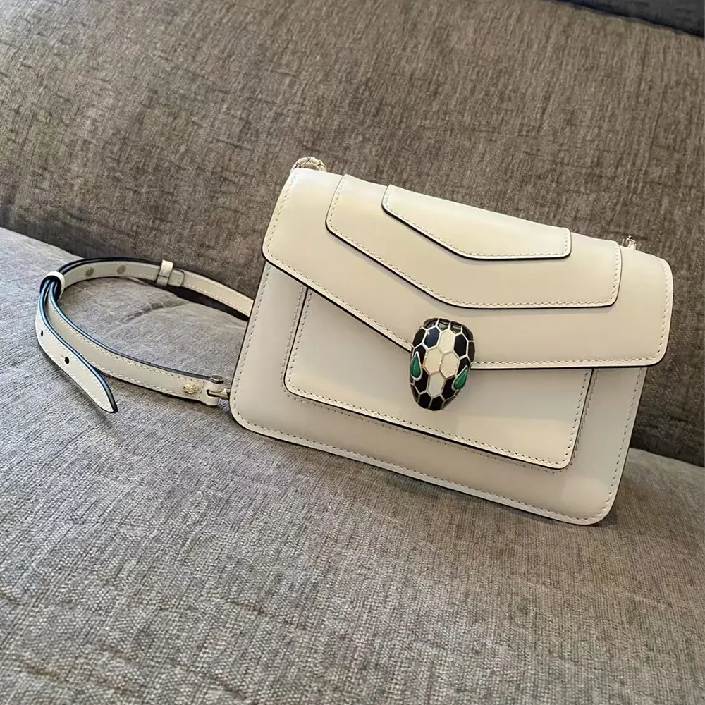 Side angle showing magnetic flap on Bvlgari white mini shoulder bag