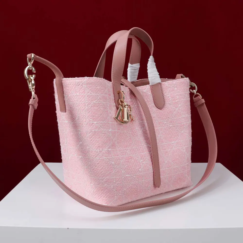 Side angle showing silver hardware and strap detail on Dior Women Medium Dior Toujours Vertical Tote Bag