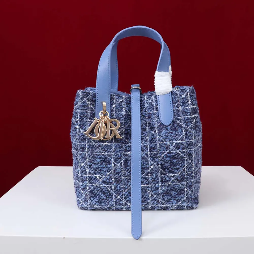 Close-up of white Cannage motif stitching on blue tweed Dior Toujours Vertical Tote Bag
