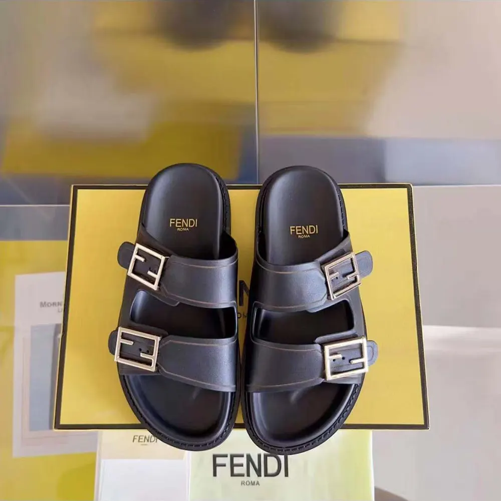 Close-up of embossed Fendi logo detail on black leather slide strap