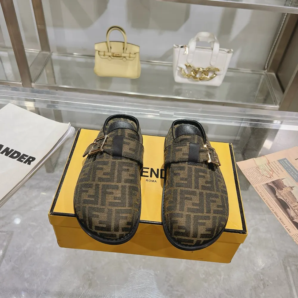 Close-up of brown fabric and Fendi hardware on sabots