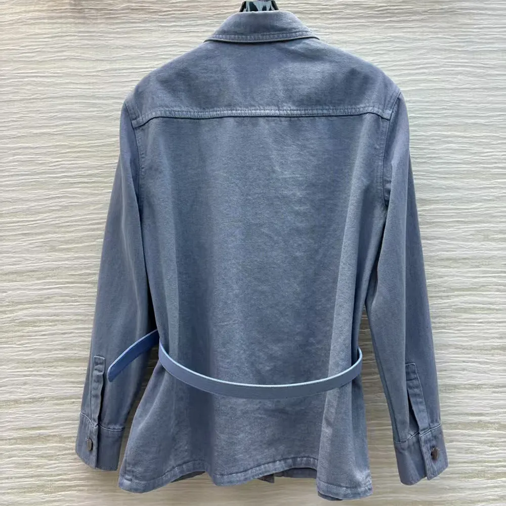 Close-up of Fendi embossed metal buttons on denim jacket