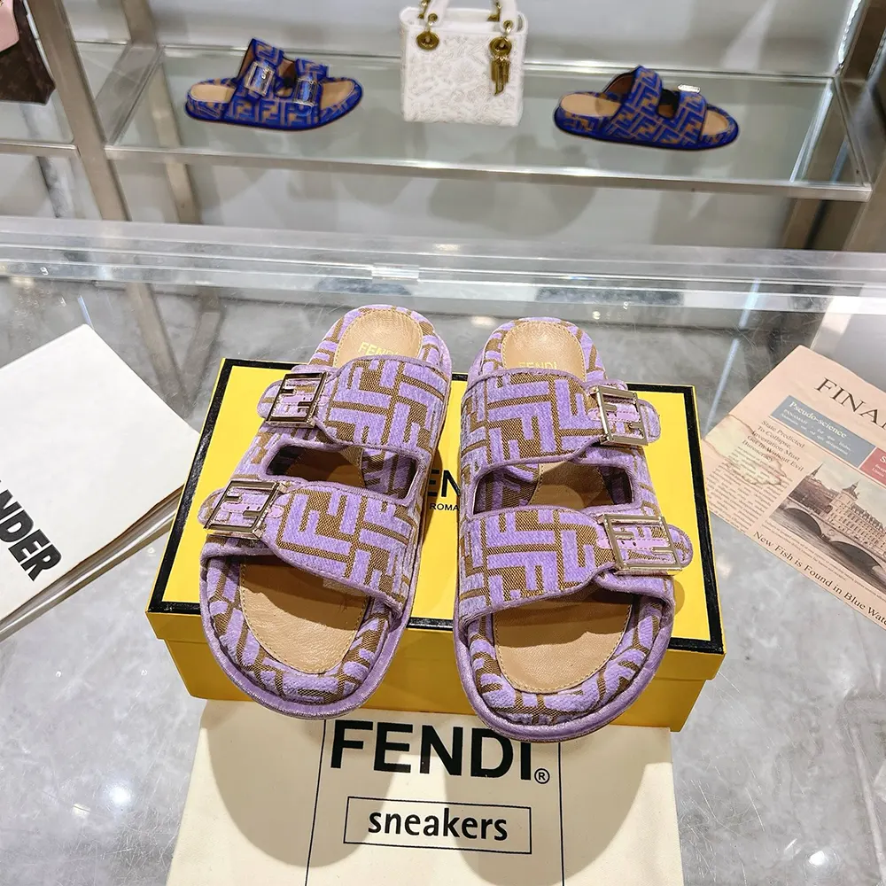 Close-up of FF logo hardware on Fendi velvet slides