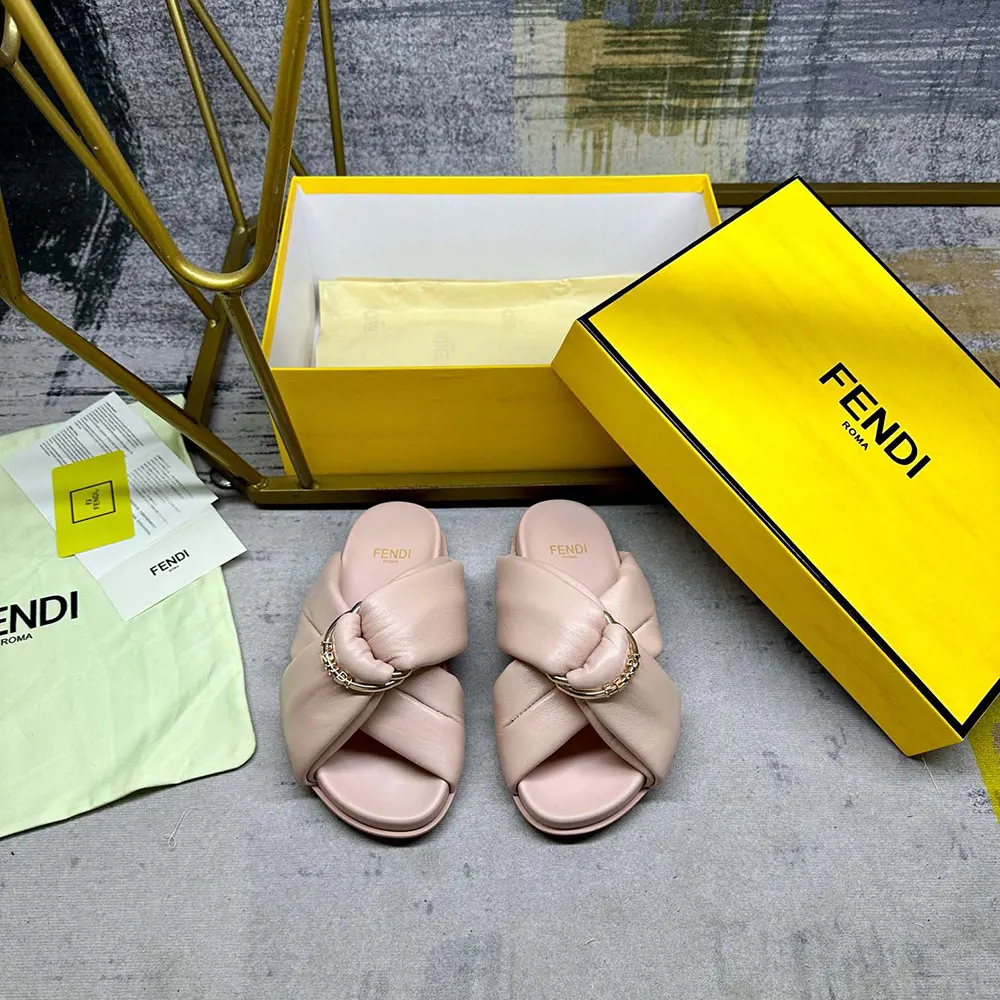 Close-up of embossed Fendi logo on pink leather slides