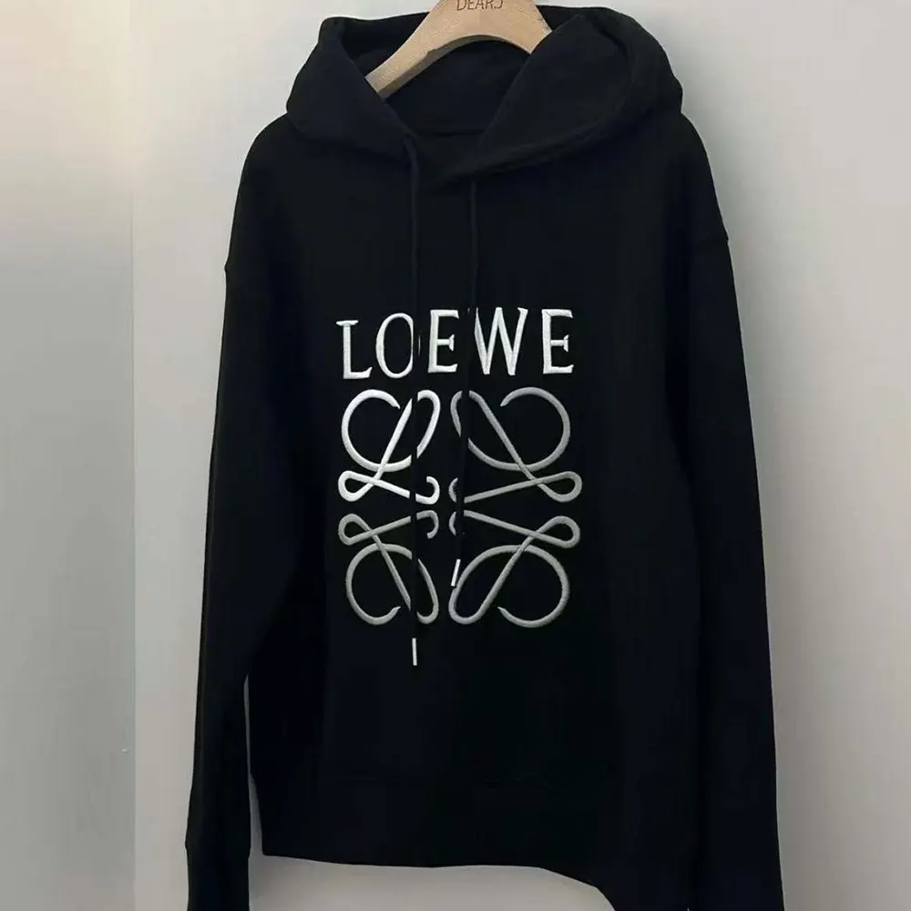 Close-up of Loewe Anagram embroidery on black cotton hoodie