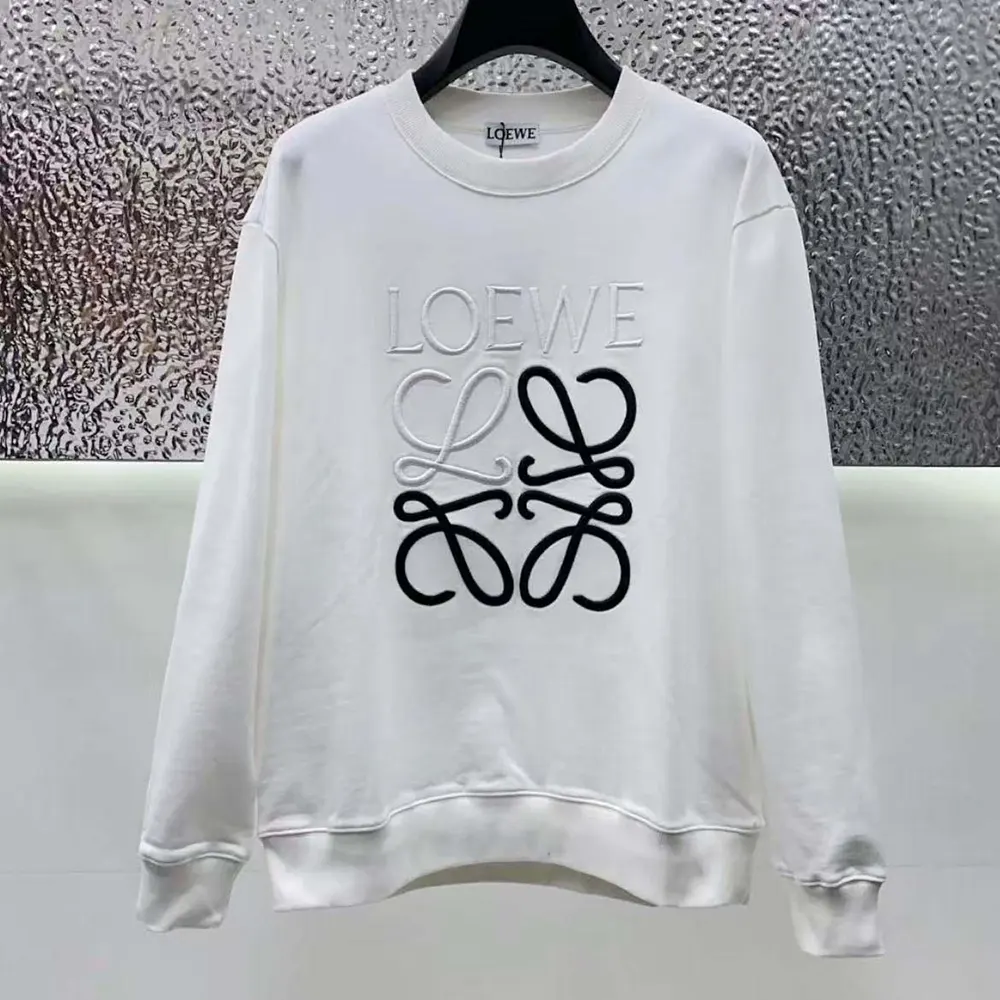 Close-up detail of embossed black Anagram on Loewe sweatshirt fabric