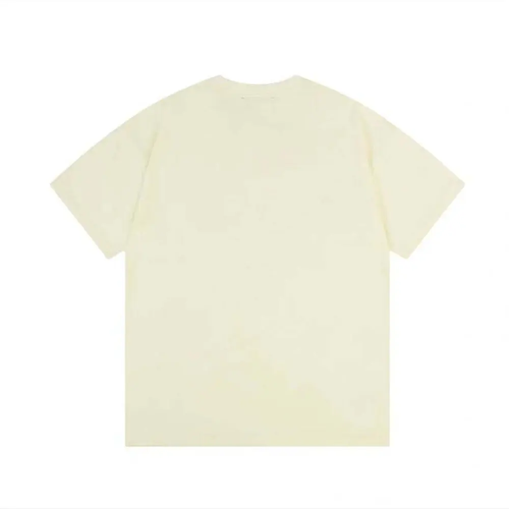 Close-up detail of gold embossed Loewe logo on white T-shirt