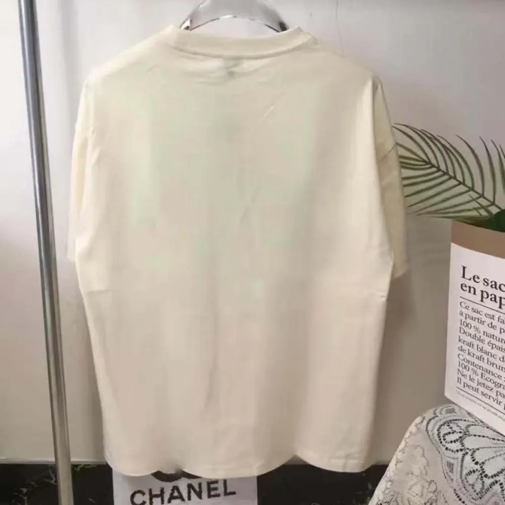 Close-up of Loewe embossed logo on white cotton T-shirt hem