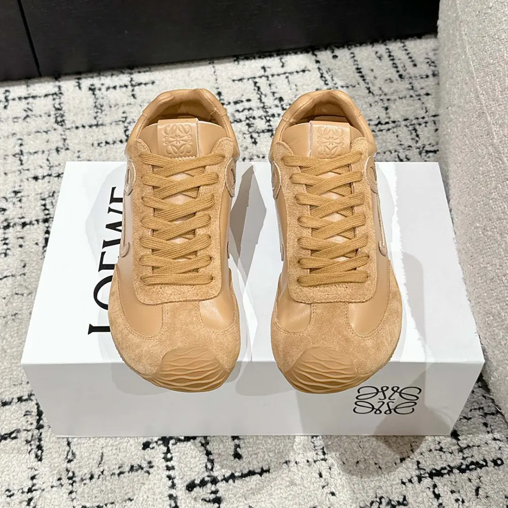 Close-up of lace closure and embossed Loewe logo on brown sneaker
