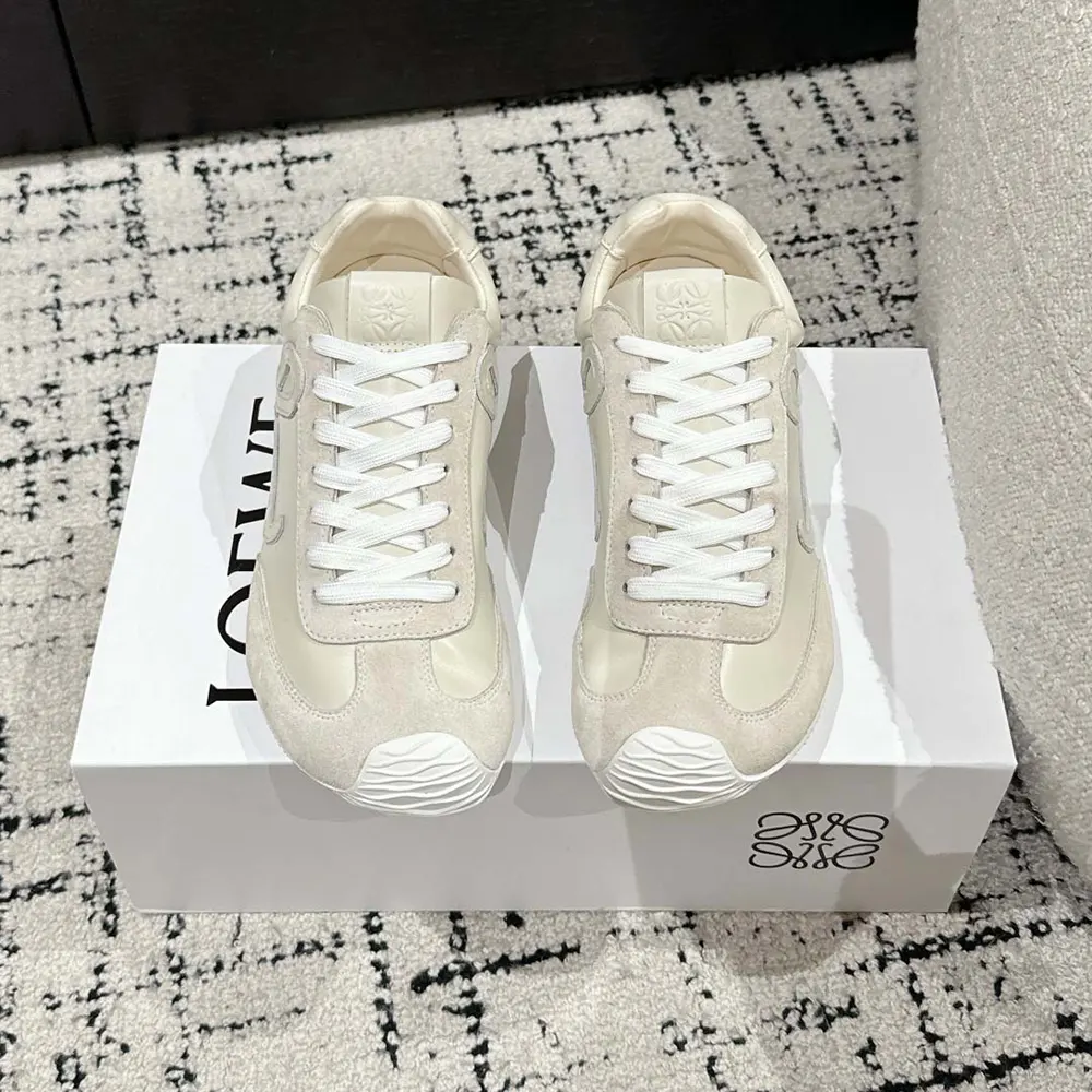 Close-up of soft white calfskin and embossed Loewe branding detail