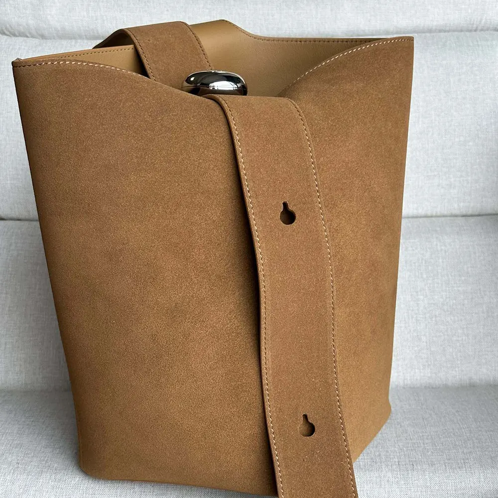 Close-up of drawstring closure and matte gold hardware on Loewe bucket bag