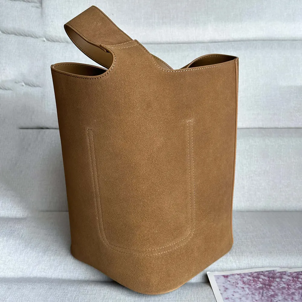 Side angle showing spacious silhouette of Loewe Unisex Large Pebble Bucket Bag