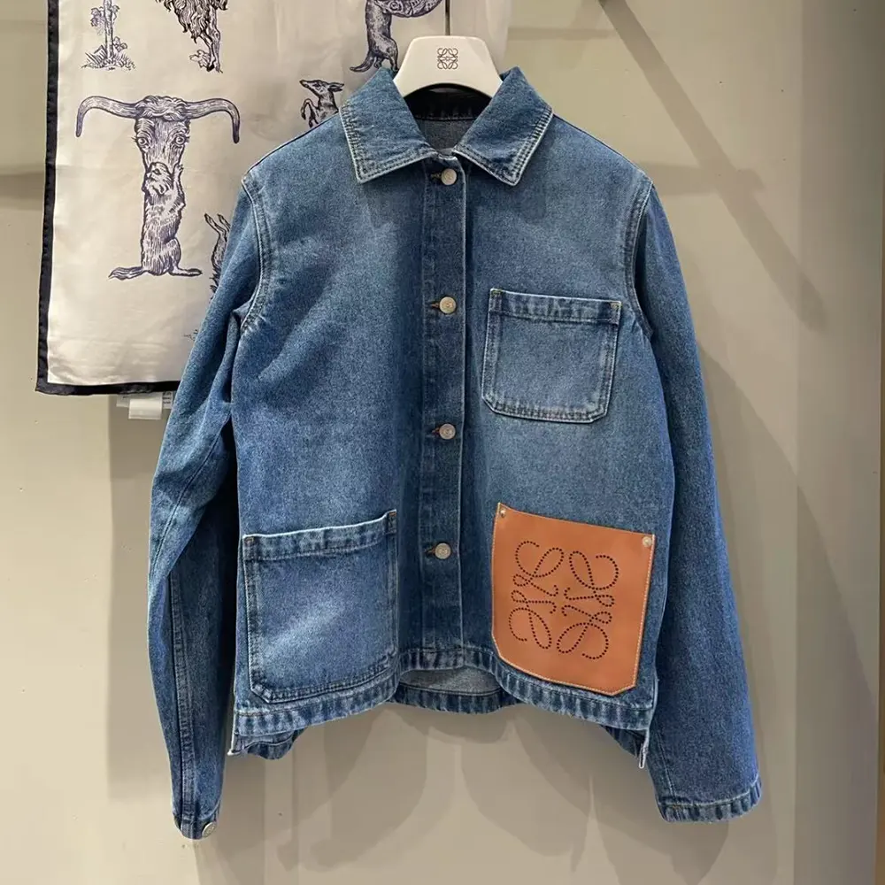 Close-up of embossed Anagram hardware on Loewe denim jacket