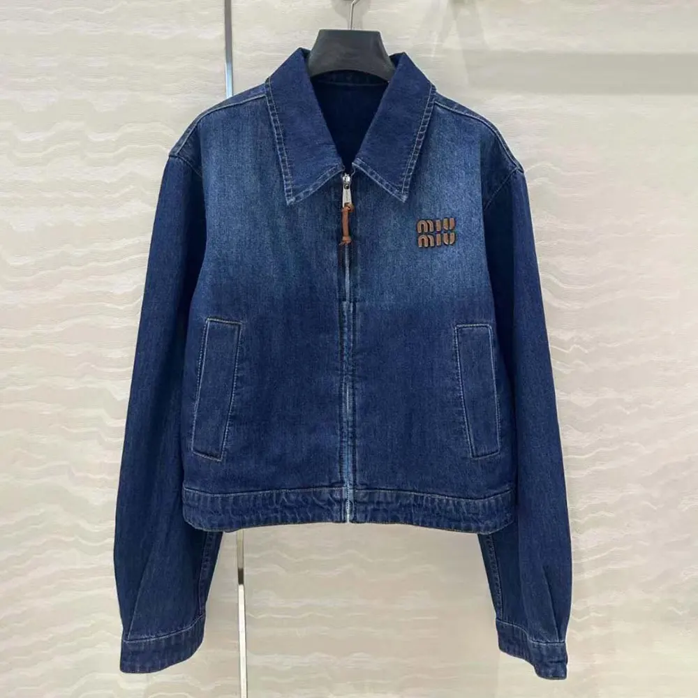 Close-up of branded metal buttons on Miu Miu Women Denim Trucker Jacket