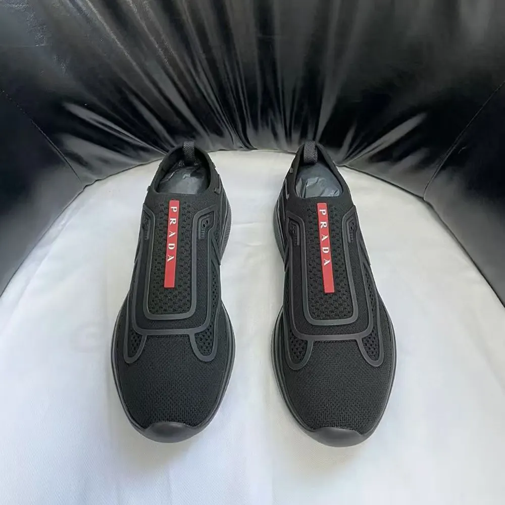Close-up of black knit texture and Prada logo on slip-on heel
