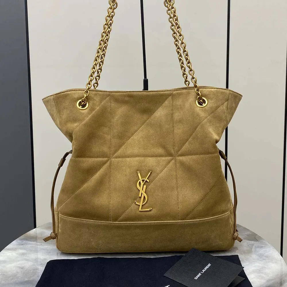 Close-up of gold YSL logo on suede-brown Jamie Shopping bag
