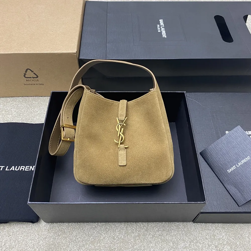 Close-up of gold YSL logo hardware on Supple Baby shoulder bag