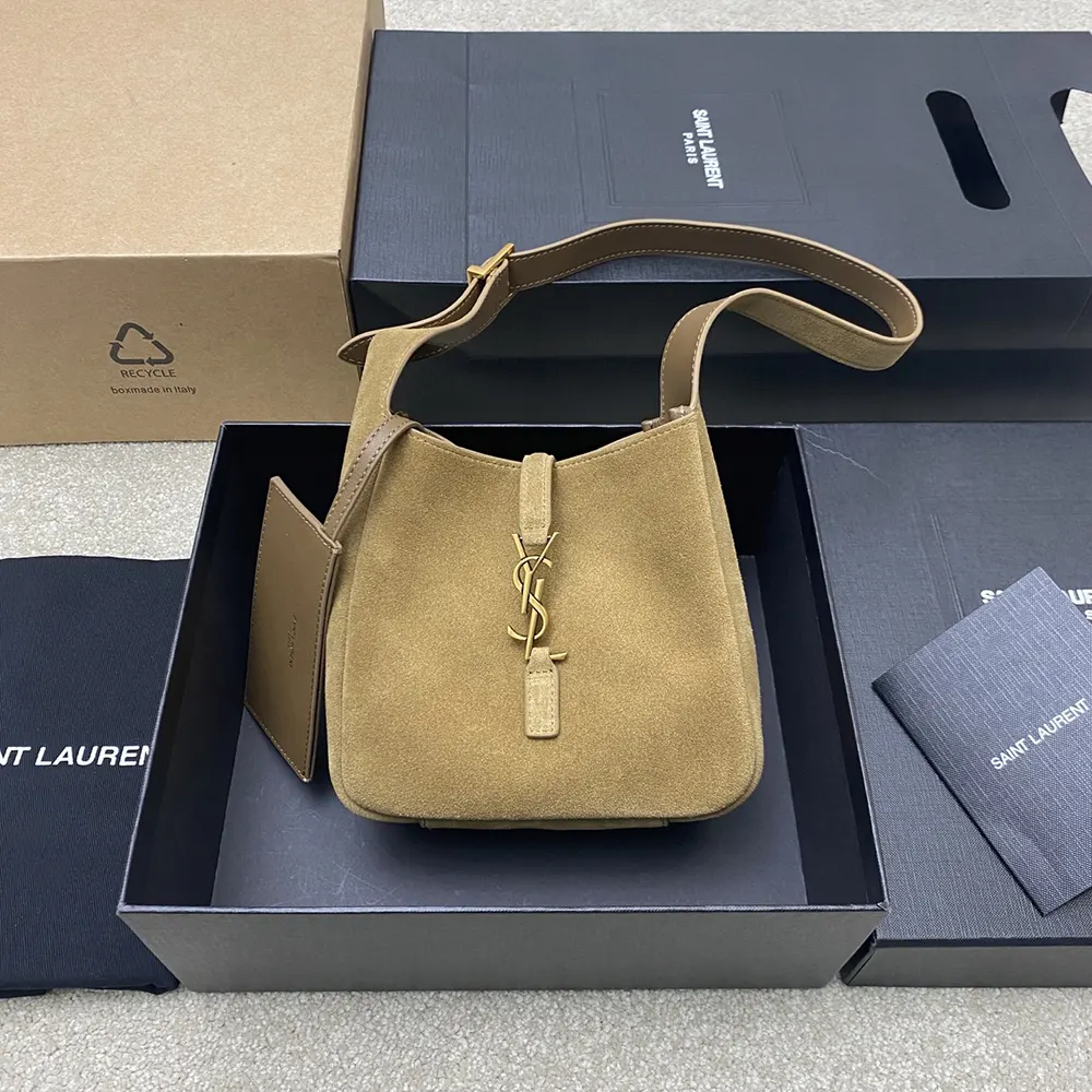 Side angle showing soft suede texture and flap closure on YSL bag
