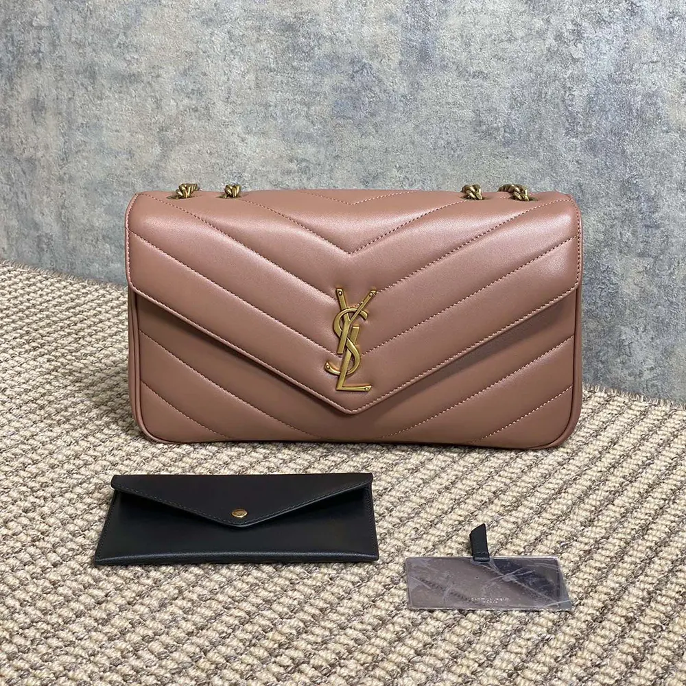 Close-up of gold YSL hardware on pink Loulou Medium bag