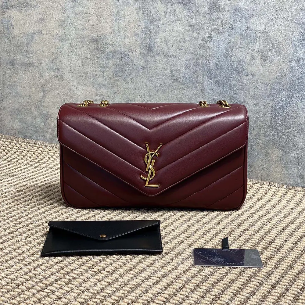 Close-up of gold YSL logo hardware on Loulou Medium bag
