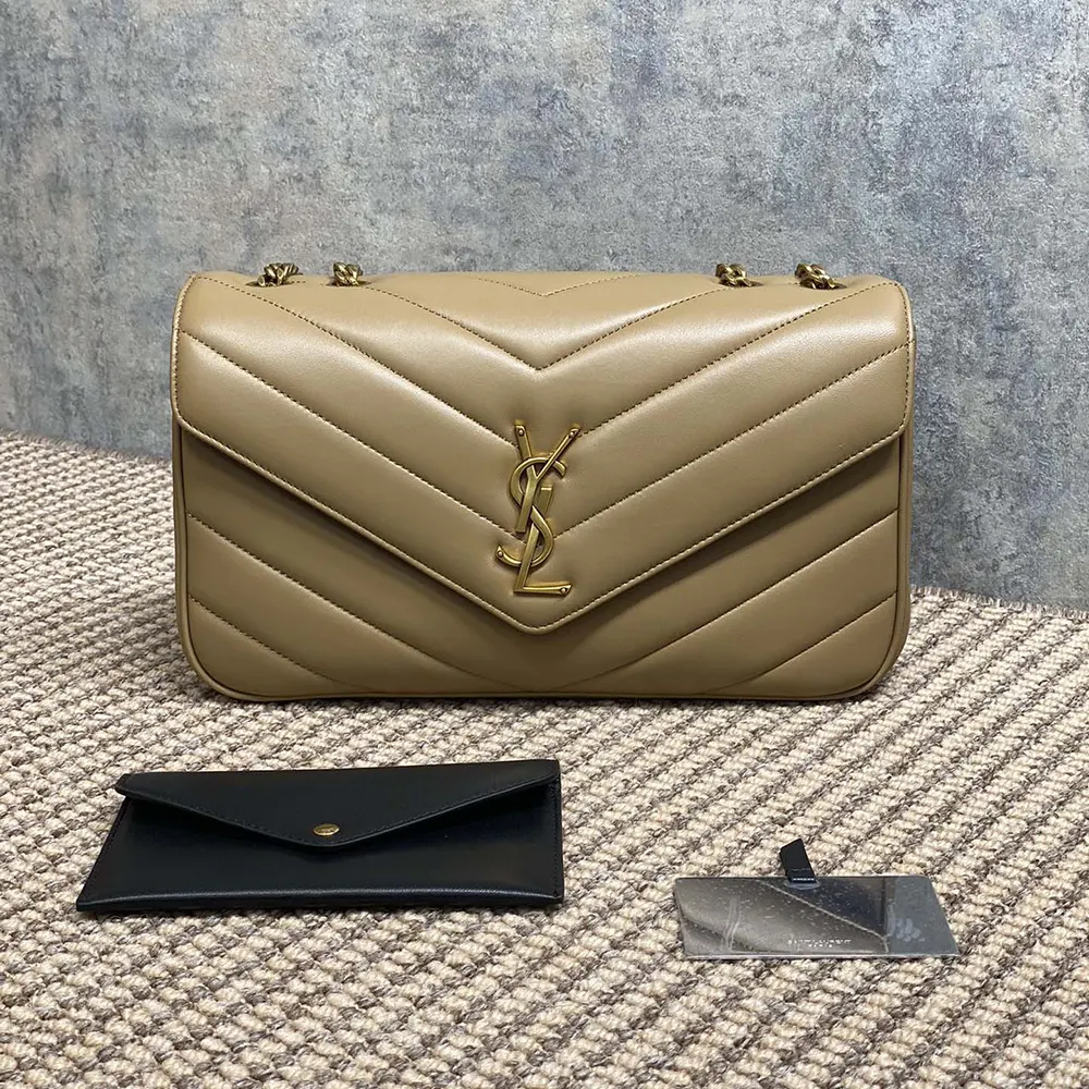 Close-up of gold-tone YSL clasp on Loulou Medium natural bag