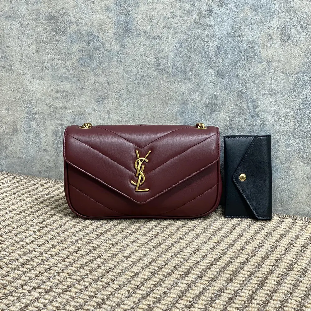 Close-up of gold YSL logo hardware on Loulou Mini Bordeaux bag