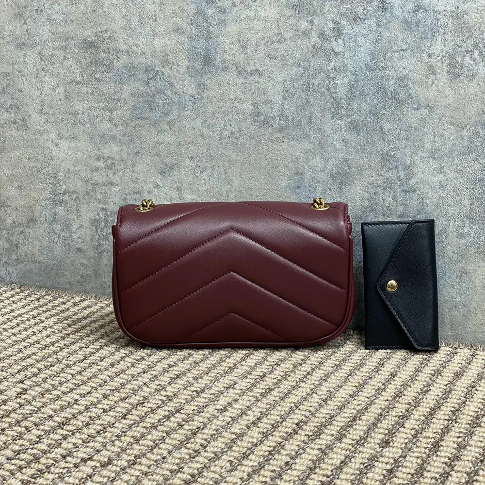 Side angle showing silhouette and lambskin texture of Loulou Mini Bordeaux
