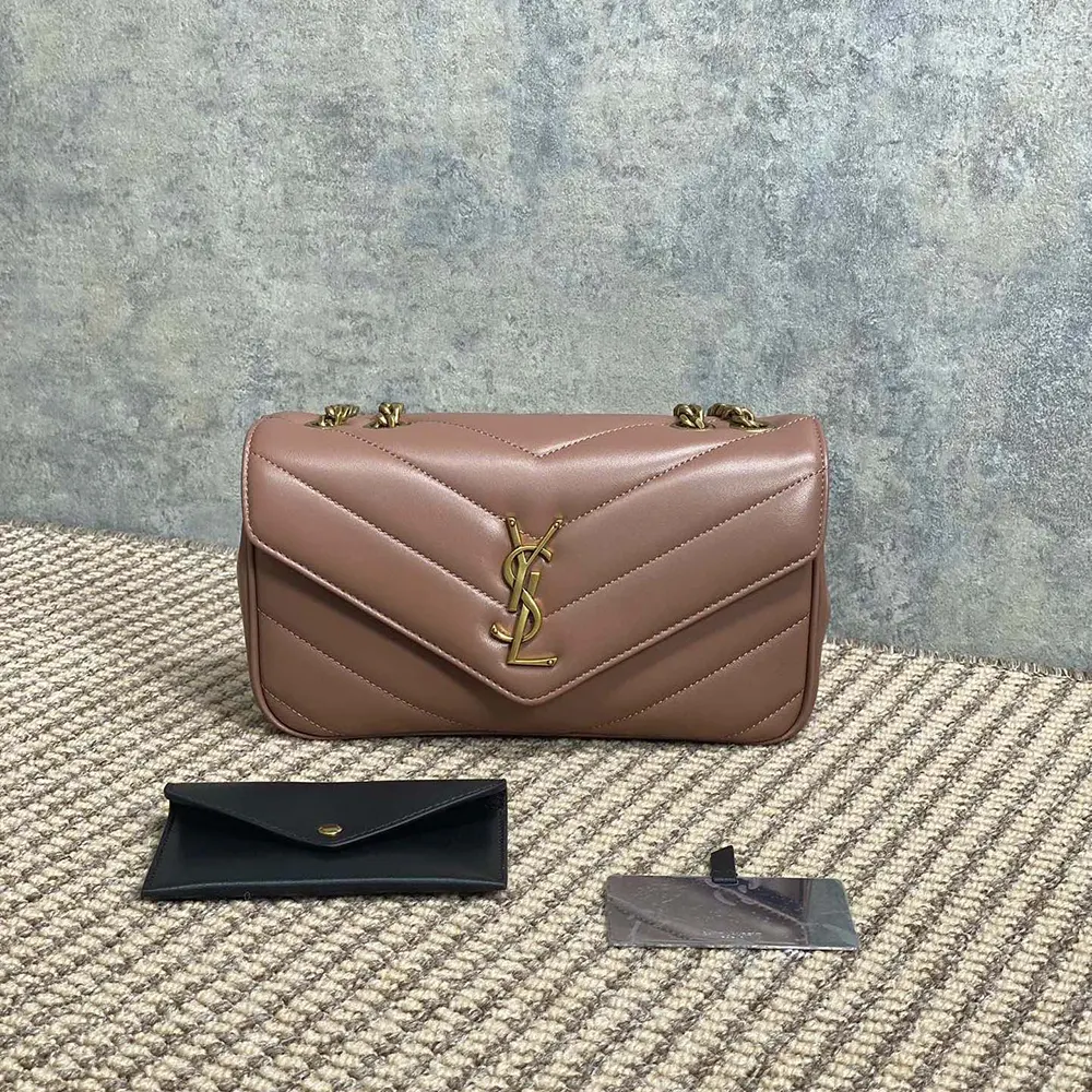 Close-up of gold YSL monogram on pink Loulou Small bag
