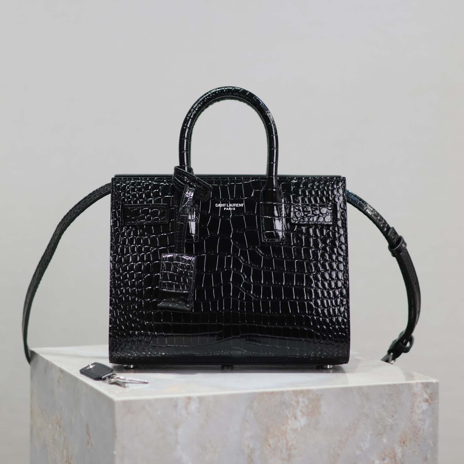 Side profile showing structure of Saint Laurent YSL Sac De Jour Nano black handbag